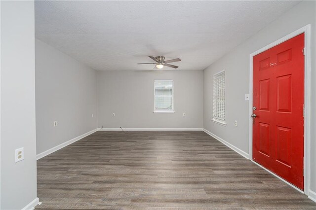 foyer with ceiling fan, dark hardwood / wood-style floors, and a textured ceiling