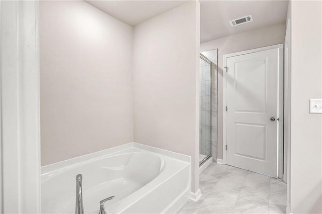 181 Dewy Rd Unit 70, Lilburn, GA 30047 - bathroom featuring a garden tub, marble finish flooring, and a stall shower