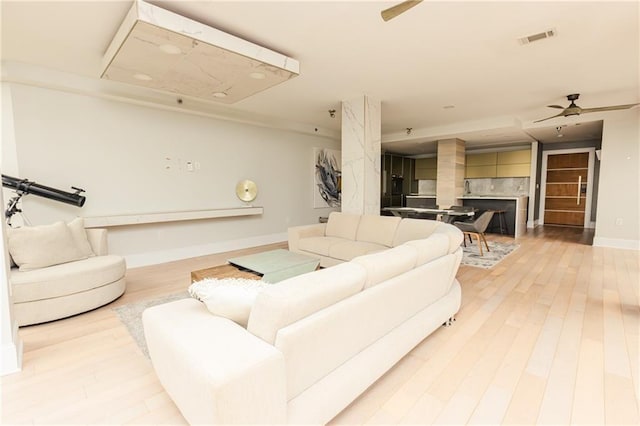 1280 W Peachtree St NW Unit 4003, Atlanta, GA 30309 - living room with a ceiling fan, light wood-style floors, and a fireplace