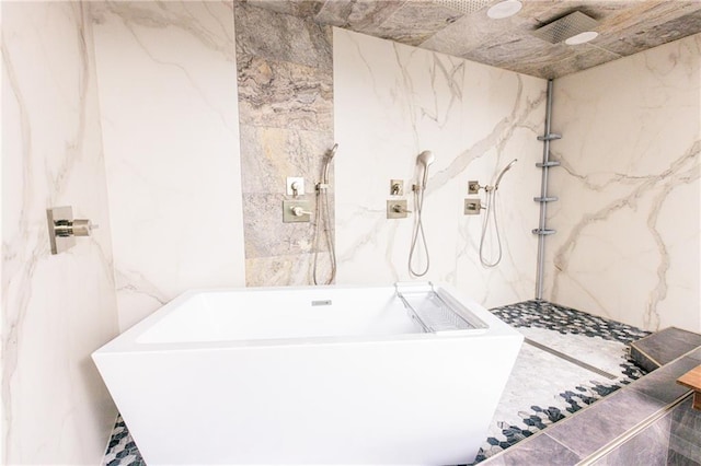 1280 W Peachtree St NW Unit 4003, Atlanta, GA 30309 - bathroom with a marble finish shower, tile walls, a freestanding bath, marble finish floors, and stone wall