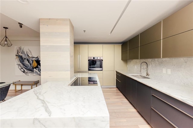 1280 W Peachtree St NW Unit 4003, Atlanta, GA 30309 - kitchen with stainless steel oven, light wood-style floors, light stone countertops, and tasteful backsplash