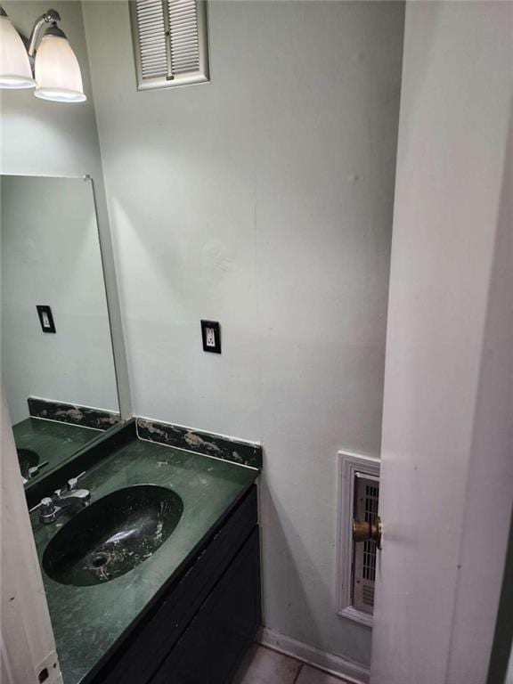 bathroom featuring tile patterned flooring and vanity