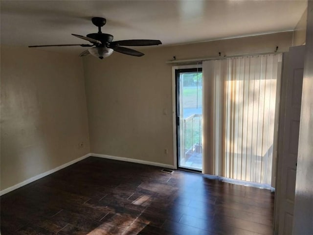 empty room with dark wood-type flooring and ceiling fan