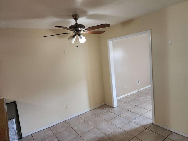 spare room featuring ceiling fan and light tile patterned floors