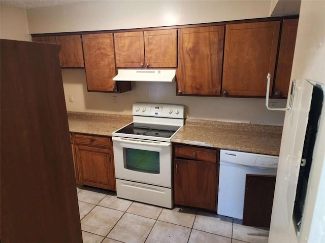 kitchen featuring white appliances and light tile patterned flooring