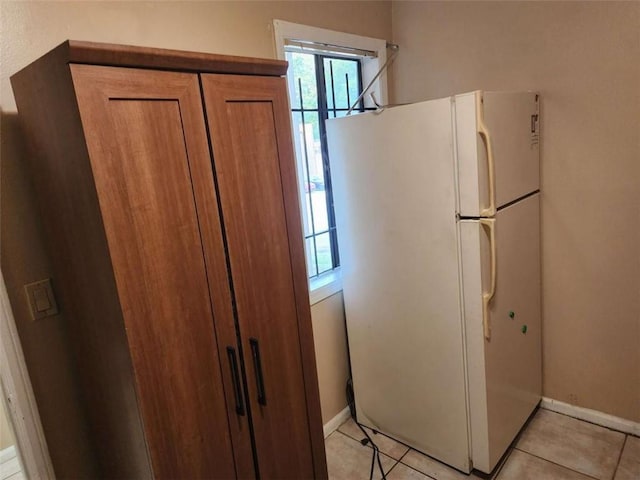 kitchen featuring light tile patterned flooring and white fridge