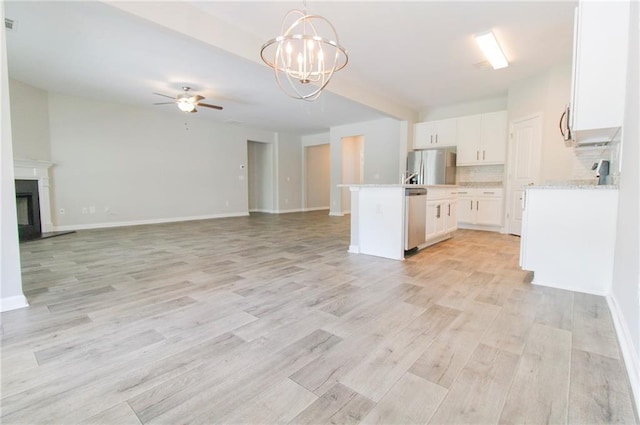 409 Glenn Trl, Winder, GA 30680 - kitchen with stainless steel appliances, open floor plan, a ceiling fan, and light wood finished floors
