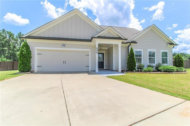 409 Glenn Trl, Winder, GA 30680 - view of front of house featuring board and batten siding, concrete driveway, and a garage