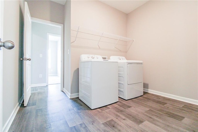 409 Glenn Trl, Winder, GA 30680 - washroom featuring separate washer and dryer and wood finished floors