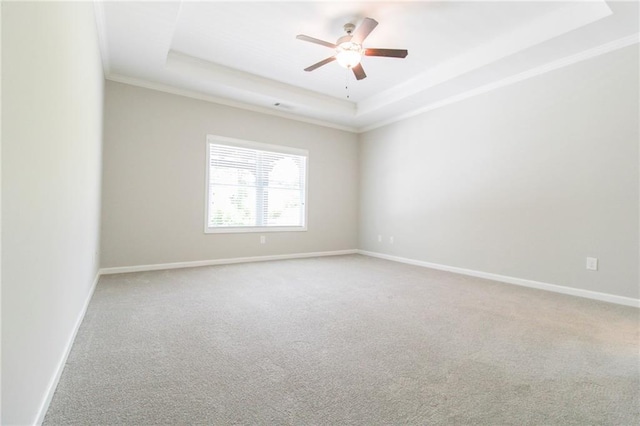 409 Glenn Trl, Winder, GA 30680 - spare room featuring a tray ceiling, ornamental molding, carpet, and a ceiling fan