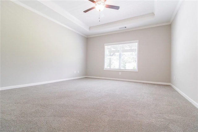 409 Glenn Trl, Winder, GA 30680 - spare room with a tray ceiling, ceiling fan, carpet, and crown molding