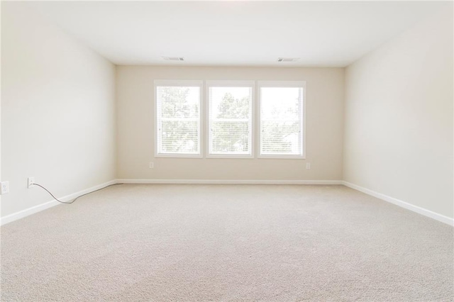 409 Glenn Trl, Winder, GA 30680 - spare room featuring light carpet and baseboards