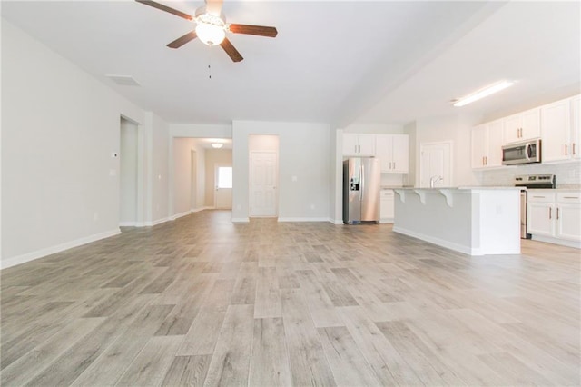 409 Glenn Trl, Winder, GA 30680 - unfurnished living room with light wood-type flooring and a ceiling fan