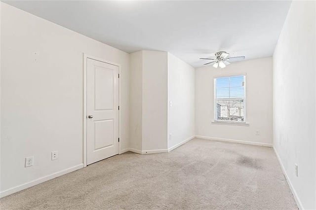 2309 Rolling Trl, Lithonia, GA 30058 - spare room with light carpet, a ceiling fan, and baseboards