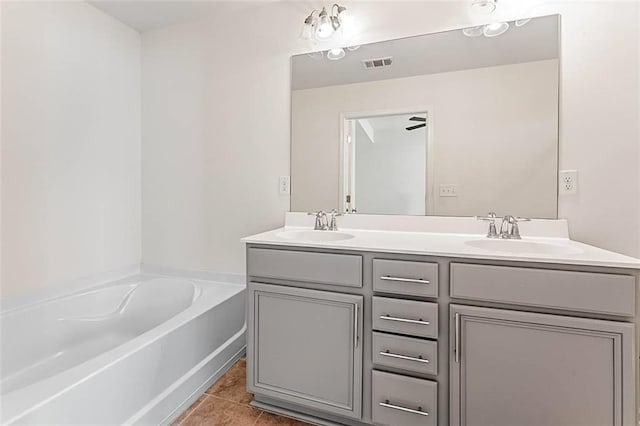 2309 Rolling Trl, Lithonia, GA 30058 - bathroom featuring double vanity, a garden tub, and tile patterned floors
