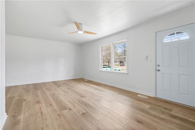 foyer entrance featuring crown molding, ceiling fan, and light wood-type flooring