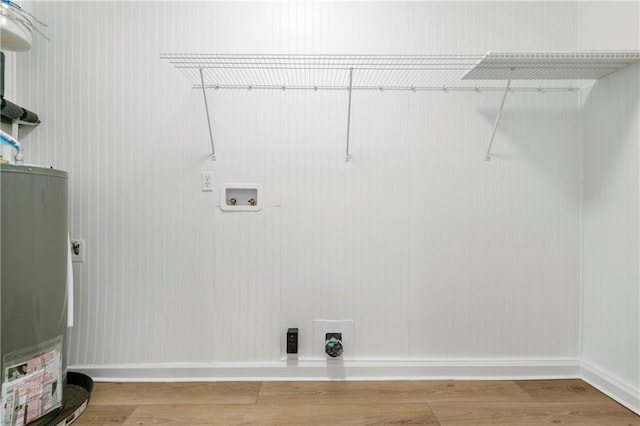 laundry area with washer hookup, gas water heater, hookup for an electric dryer, and wood-type flooring