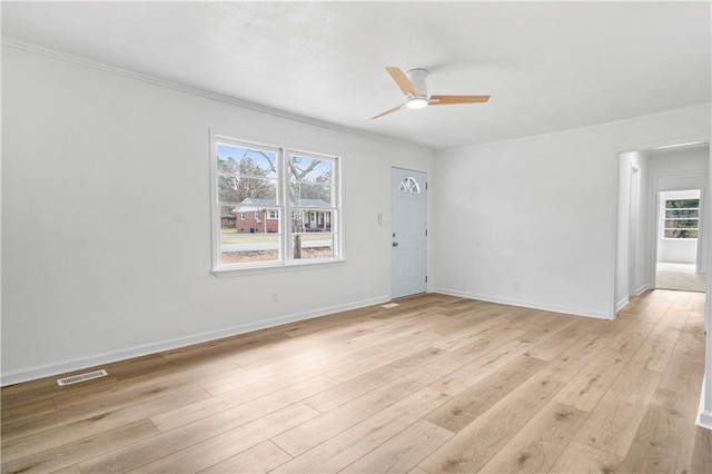 empty room featuring crown molding, ceiling fan, and light hardwood / wood-style floors