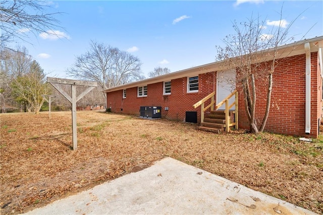 back of house with central AC