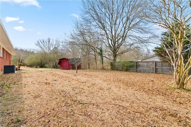 view of yard featuring central AC and a shed