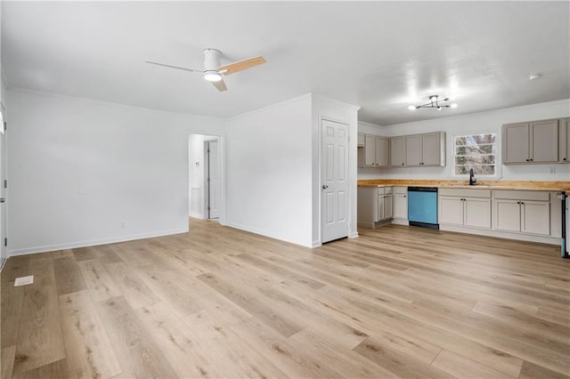 kitchen featuring sink, crown molding, light hardwood / wood-style flooring, wood counters, and stainless steel dishwasher