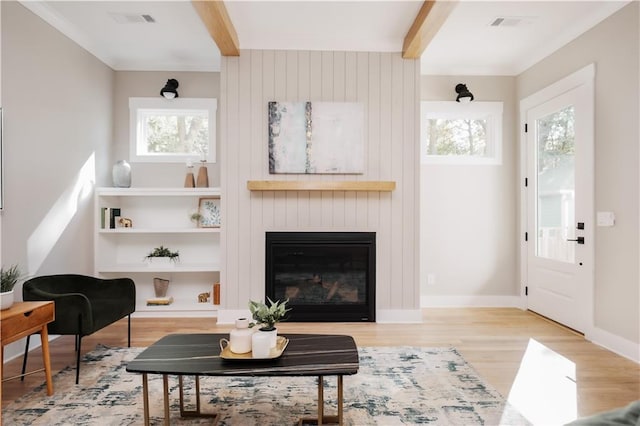 living room with light hardwood / wood-style flooring and a large fireplace