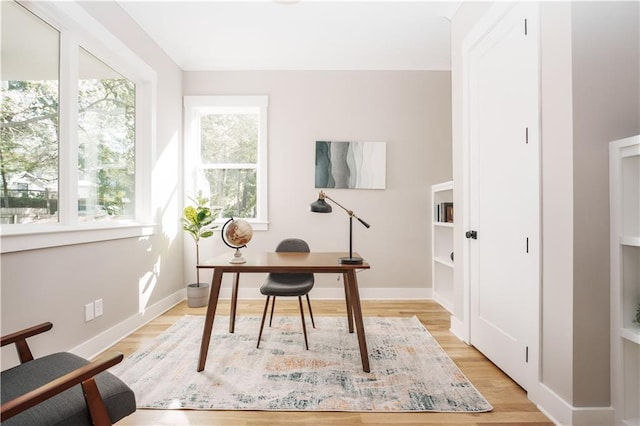 office with light wood-type flooring