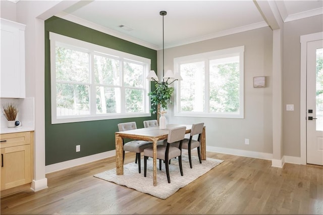 dining area featuring light hardwood / wood-style floors and ornamental molding