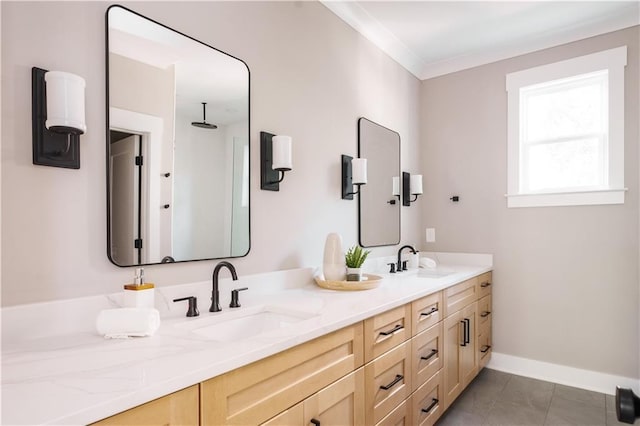 bathroom with vanity, ornamental molding, and tile patterned flooring