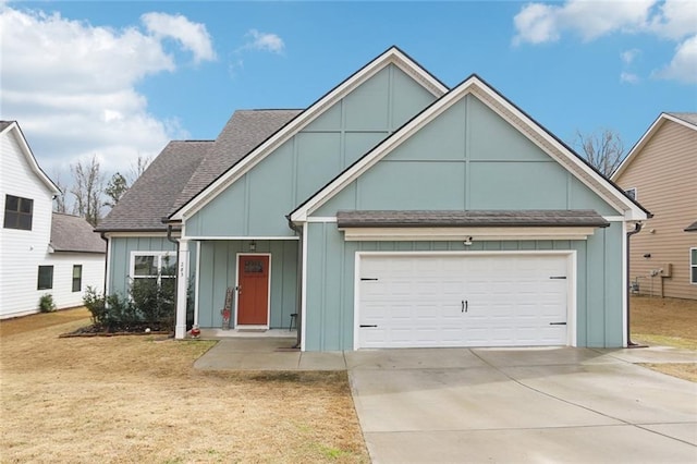 view of front of home with driveway, roof with shingles, board and batten siding, an attached garage, and a front yard