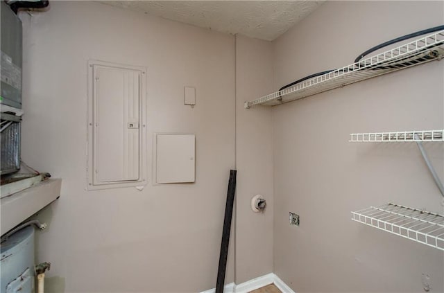 laundry room with baseboards, hookup for an electric dryer, laundry area, and electric panel
