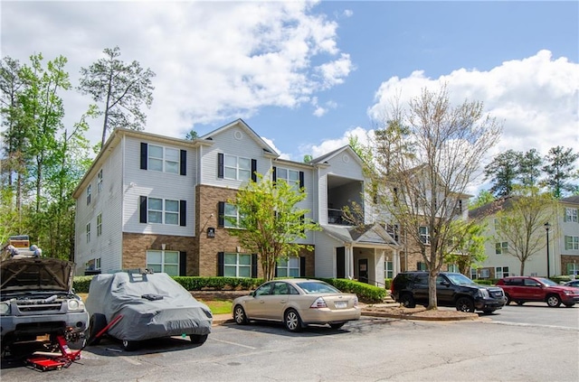 view of property featuring uncovered parking