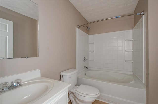 full bathroom with washtub / shower combination, vanity, a textured ceiling, and toilet