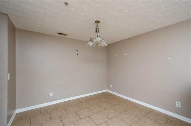 spare room with light tile patterned floors, baseboards, and visible vents