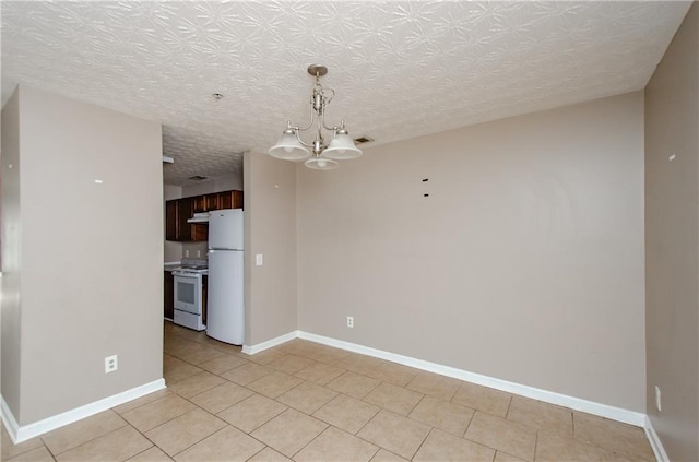 interior space featuring a notable chandelier, baseboards, light tile patterned floors, a textured ceiling, and visible vents