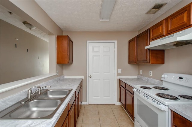 kitchen featuring visible vents, a sink, light countertops, under cabinet range hood, and white electric range