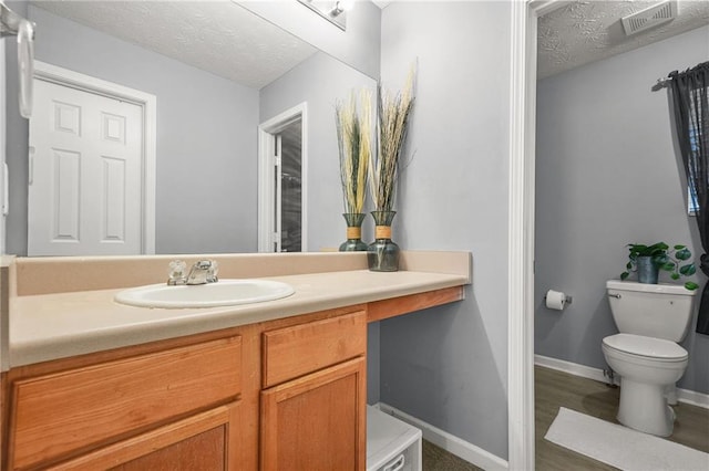 30 Creek Bottom Dr, Covington, GA 30014 - bathroom with vanity, a textured ceiling, and wood finished floors