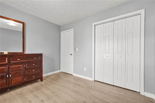 30 Creek Bottom Dr, Covington, GA 30014 - unfurnished bedroom featuring wood finished floors, a closet, and a textured ceiling