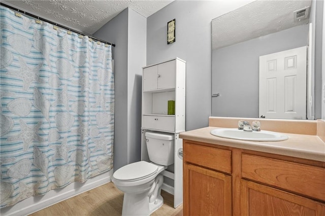 30 Creek Bottom Dr, Covington, GA 30014 - full bath with a textured ceiling, vanity, wood finished floors, and shower / tub combo