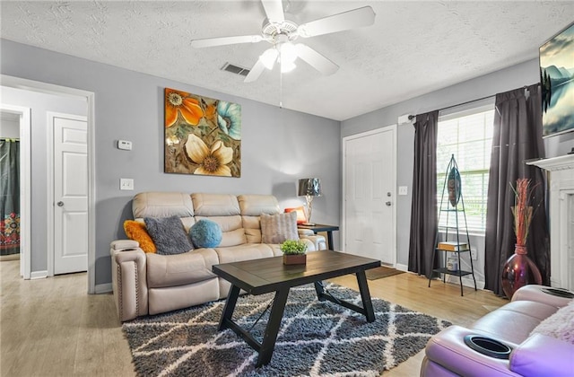 30 Creek Bottom Dr, Covington, GA 30014 - living room with light wood finished floors, a textured ceiling, and ceiling fan