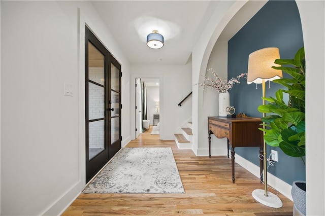 foyer entrance featuring french doors and hardwood / wood-style floors