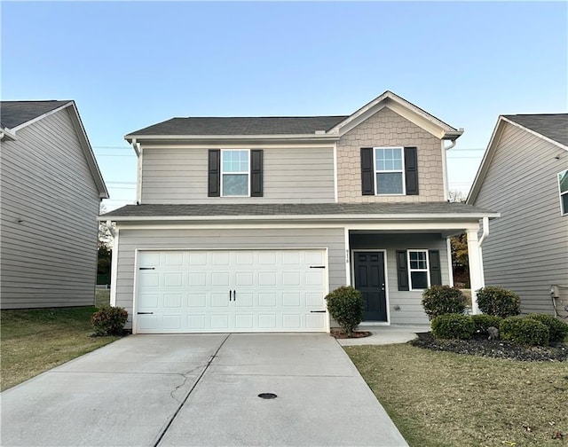 view of front of house featuring a front yard and a garage