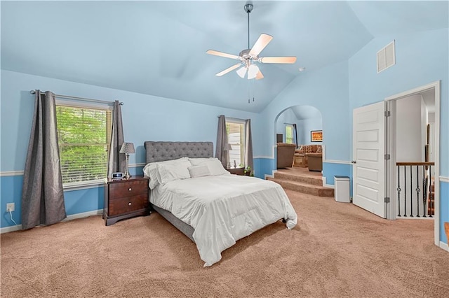 bedroom with visible vents, multiple windows, arched walkways, and carpet flooring