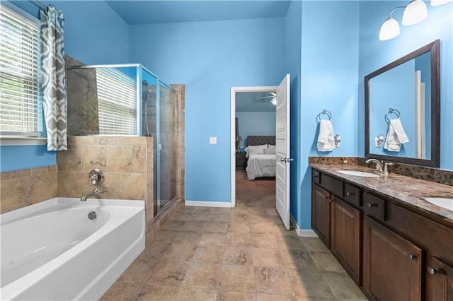 ensuite bathroom featuring a sink, a shower stall, double vanity, ensuite bath, and a garden tub