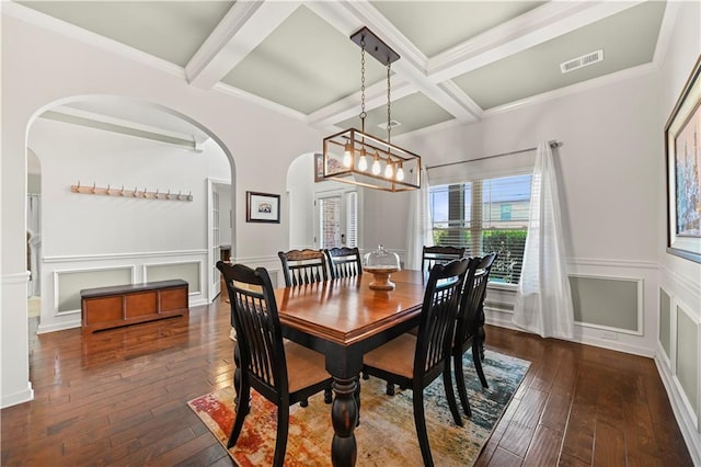dining space featuring arched walkways, wood-type flooring, visible vents, and beamed ceiling