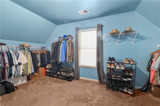 spacious closet with carpet, visible vents, and lofted ceiling