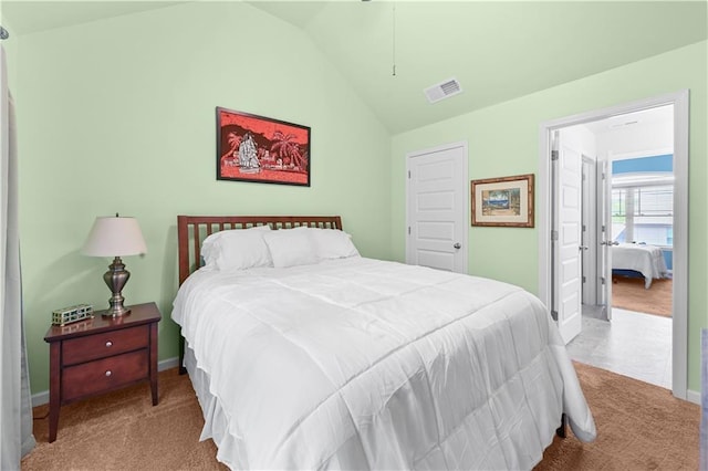 carpeted bedroom featuring visible vents, baseboards, and lofted ceiling