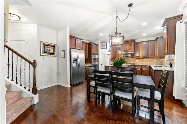 dining room with recessed lighting, baseboards, dark wood finished floors, and stairway