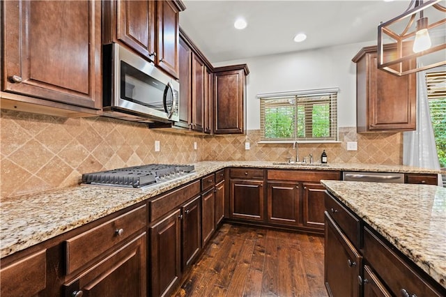 kitchen featuring dark wood-type flooring, a sink, a wealth of natural light, and stainless steel appliances