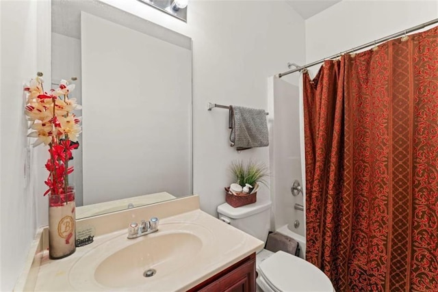 full bath featuring shower / bath combo with shower curtain, toilet, and vanity